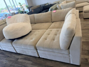 Cream sectional sofa by the showroom window at DT’s Outlet