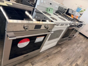 Row of stainless steel kitchen ranges on the floor
